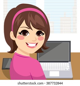 Young woman sitting at desk working smiling and looking back