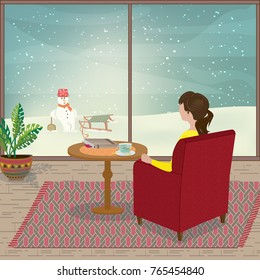 A Young Woman Is Sitting In Her Armchair Looking Out Of The Window As Snow Falls