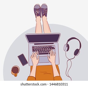 Young woman sitting on floor and working on laptop computer