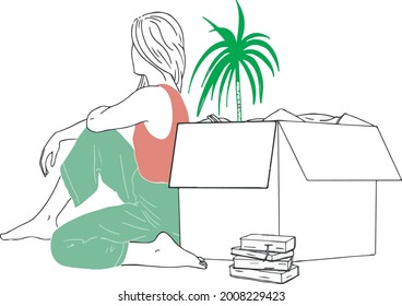 Young woman sitting on floor near box, plant and books. Home concept. Moving. 