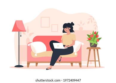 Young woman sitting on sofa and working on laptop from home