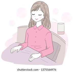 A young woman is smelling aroma in bed.