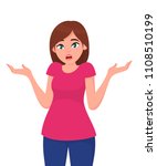 Young woman spread her hand and shrugging shoulder.  I do not know. Oops! Sorry! Asking question and doubt expression.
