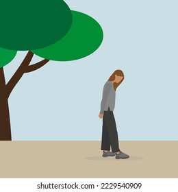 Young woman standing and looking down in the park