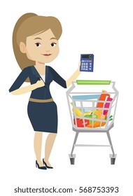 Young woman standing near supermarket trolley with calculator in hand. Woman checking prices on calculator. Woman counting on calculator. Vector flat design illustration isolated on white background.
