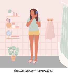 Una joven se para y peina el pelo. Una bonita mujer en el cuarto de baño. Ilustración vectorial plana.