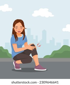 Young woman suffering from knee pain when exercising in the park