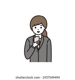 A young woman in a suit operating a smartphone