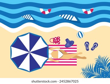 Young woman sunbathing on towel. Resort on summer holidays. Girl rests on the beach under umbrella