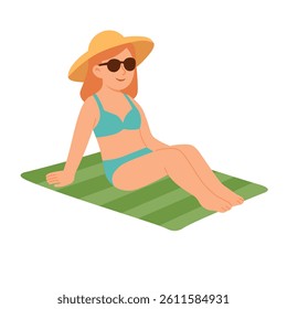 Young woman in swimsuit, hat and sunglasses relaxing on green mat under summer sun.