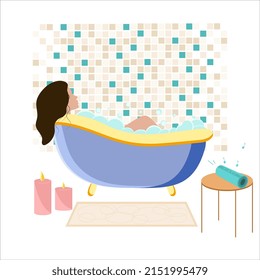 Young woman taking a relaxing hot bath in a bathtub with bubbles