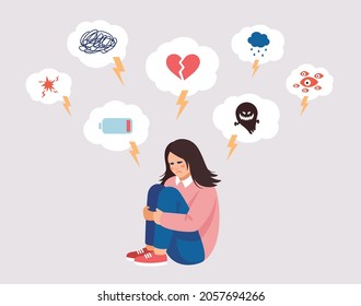 Young woman, teenager is suffering from mental health diseases, sitting on the floor.Girl is surrounded by symptoms of  depressive disorder: anxiety, tears, loss, paranoia, phobias.