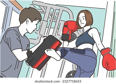 Young woman and trainer doing martial arts kicks
