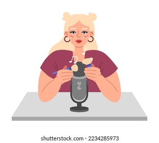 Young woman using brush on microphone to make whisper, rustling, tapping, quiet crunch. ASMR broadcasting concept. Pleasant sounds for goosebumps.