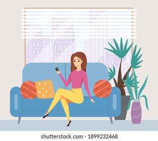 Young woman using her phone while sitting on the couch. Female character takes a selfie at home against the background of a window with skyscrapers. A woman uses modern technology in her apartment