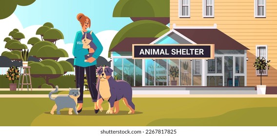 young woman volunteer with dog and cat generation Z lifestyle animal shelter concept horizontal