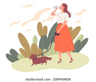 Young woman walking her dog and drinking water