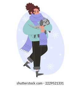 Young woman walking with a small curly dog in winter