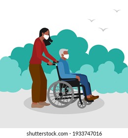 Young woman walks in park with  elderly man in wheelchair
