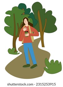 a young woman walks through the forest and enjoys being alone. drinking coffee, listening to music. introvert