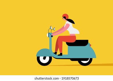 Young woman wearing helmet rides a scooter