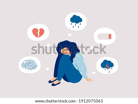 Young woman who suffers from mental health diseases is sitting on the floor. Girl surrounded by symptoms of depression disorder: anxiety, crisis, tears, exhaustion, loss,  overworked, tired.