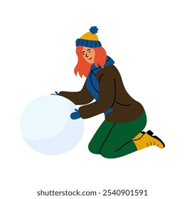 Uma jovem mulher em trajes de inverno constrói uma bola de neve enquanto se ajoelha na neve durante um dia de neve