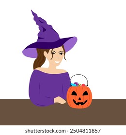 A young woman in a witch costume puts candy in a bucket in the form of a pumpkin