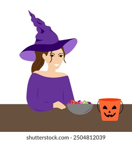 A young woman in a witch costume puts candy from a Halloween bucket into a bowl