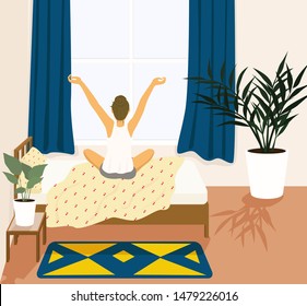 young woman woke up and stretching in bed room.