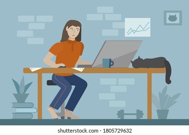 Young woman working with laptop in her home, there are plants, books, photo frame and slipping cat on the table. Work from home concept.