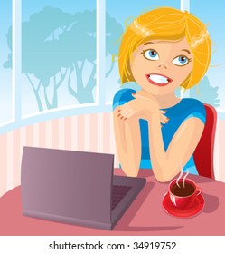 The young woman works behind the laptop with a coffee cup