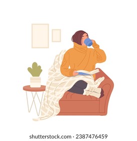 Young woman wrapped in plaid, drinking hot tea and reading book at home enjoying cozy autumn