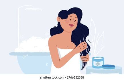 Young woman wrapped in a towel in her bathroom applying mask from the jar on her wet long hair after the shower. Girl enjoying beauty ritual. Everyday beauty routine. Women hygiene and self care.