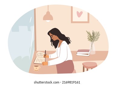 Young woman writing and studying at cafe.
