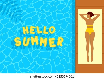 Young woman in a yellow swimsuit lying on a beach towel by the blue pool. Yellow inflatable letters hello summer floating on the water surface