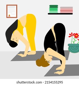 Young women practicing yoga, doing uttanasana exercise at yoga class, standing in half forward bend pose, working out. Healthy and fitness concept.