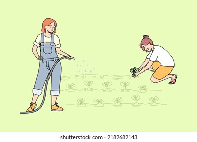 Young women working in garden watering plants together. Female cartoon characters involved in farming or agriculture at plantation. Vector illustration. 