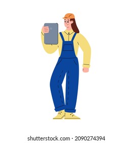 Young worker in overalls, helmet holds tablet computer in his hands. Cartoon male engineer controls workflow through application in flat vector illustration isolated on white background.