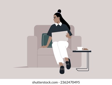 A youthful and self-assured woman sits comfortably on a sofa, immersed in her daily activities, her laptop open and at hand