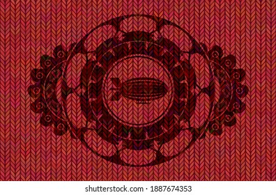 zeppelin icon inside Red color woolen fabric badge. Cloth graceful background. Intense illustration. 