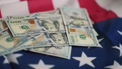 dollar money and American flag. bankrupt man counting money cash. business crisis finance dollar concept. close-up of a hand counting paper dollars. exchange finance economy usd dollar pay tax