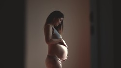 pregnant woman. health pregnancy motherhood indoors procreation concept. close-up belly of a pregnant woman. woman waiting for a newborn baby. pregnant woman holding her belly sunlight