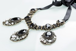 black necklace with stones on white 