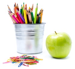 Photo of office and student gear with Color pencils in aluminum pencil  holders, Back to school supplies 