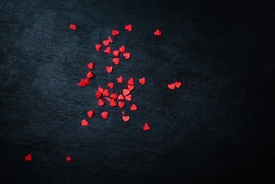 Beautiful valentines day background with red hearts on black background