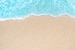 Background image of Soft wave of blue ocean on sandy beach.  Ocean wave close up with copy space for text
