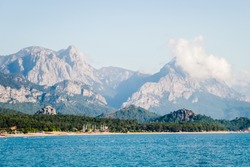 A view of the peaks of the Taurus Mountains and aquamarine water in popular touristic resort on Mediterranean sea in Turkey