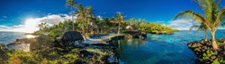 Panoramic paradise holoidays location with coral reef and palm trees on south side of Upolu, Samoa Islands.