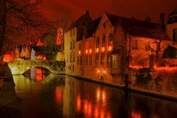 HDR after sunset view of Brugge, Belgium with frozen channel and stone bridge